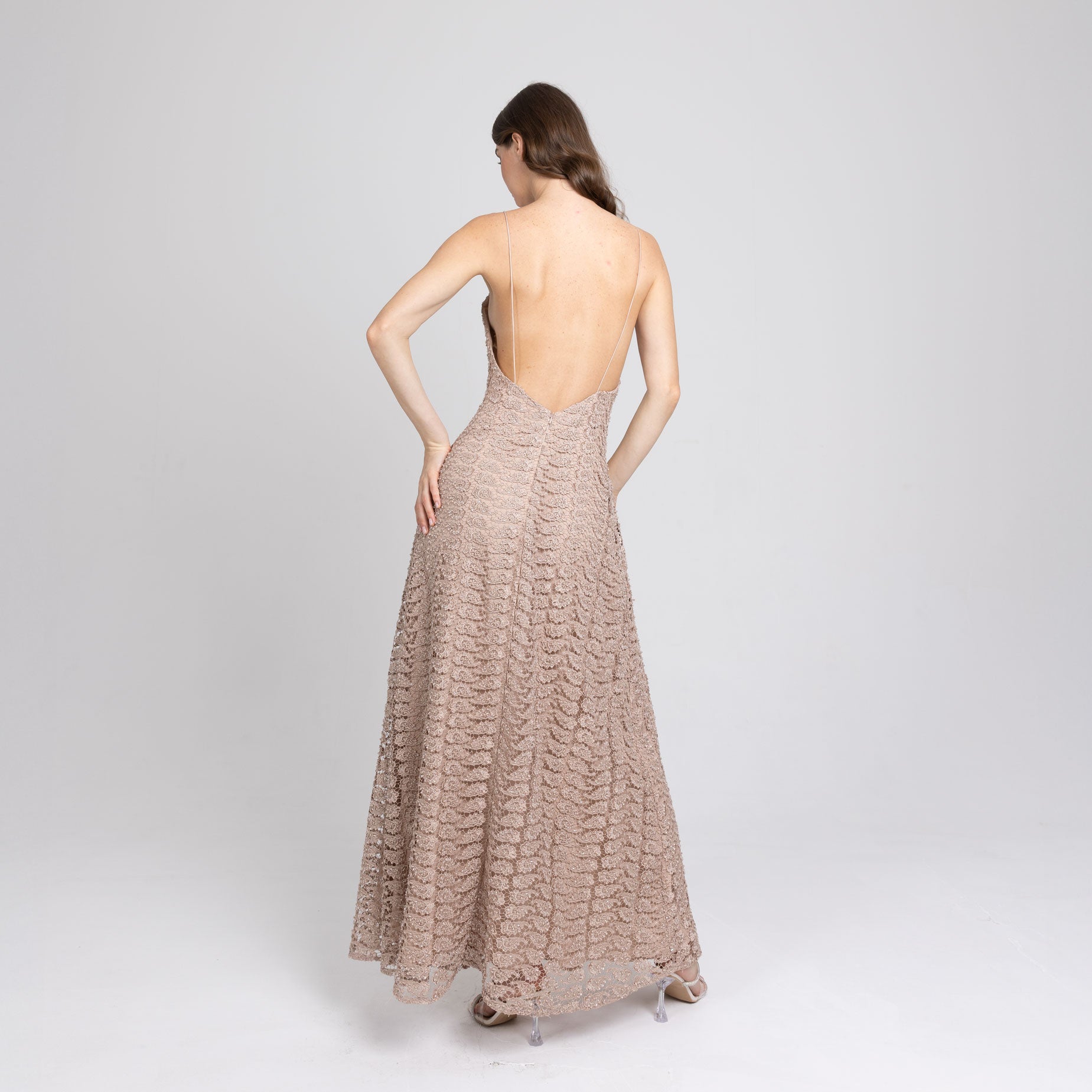 Side view of long nude lace gown with delicate satin straps and soft drape