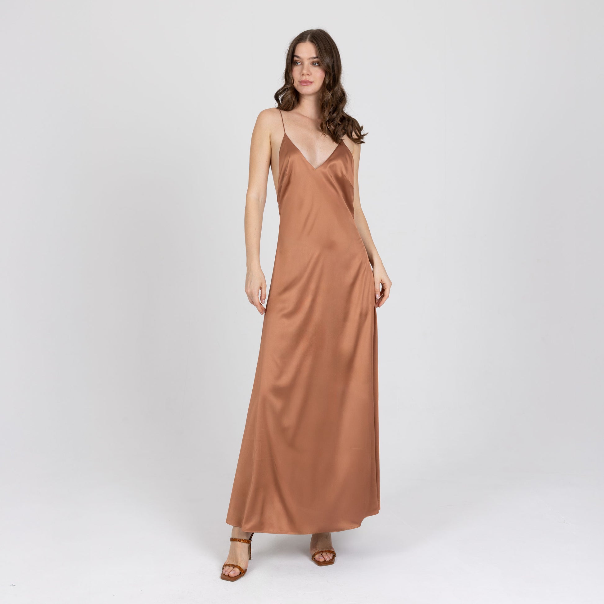 Model wearing copper satin long dress with deep V neckline – Seréa by A|LOUD