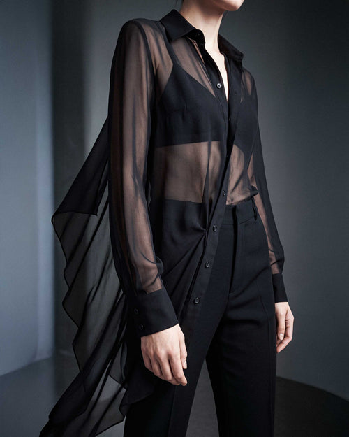 Side detail of the black sheer silk chiffon shirt showing the transparent fabric, long sleeves and asymmetric draped hem by A|LOUD