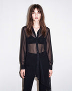 Front view of the black sheer silk chiffon shirt styled with black tailored crepe trousers by A|LOUD
