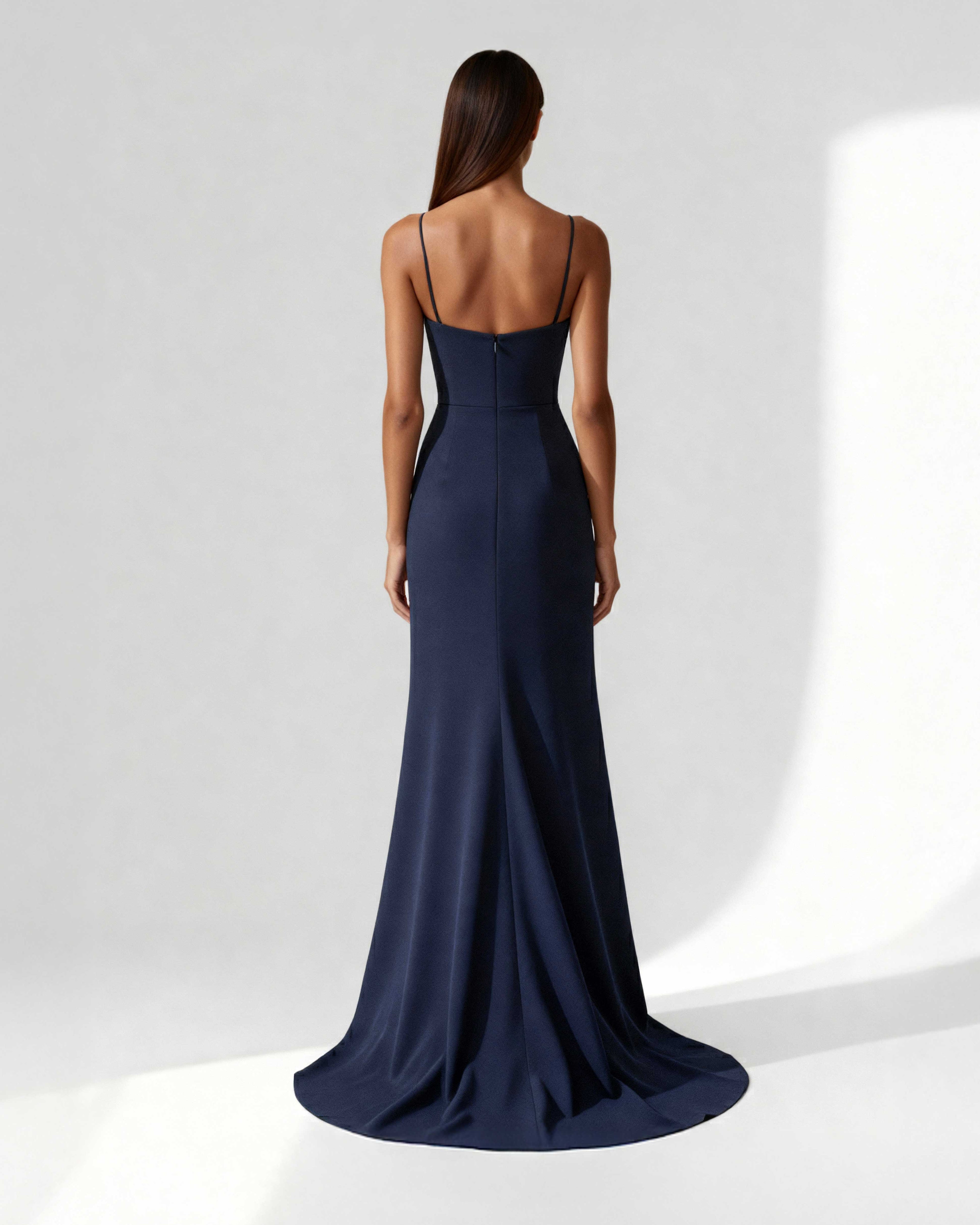 Back view of navy crepe gown with thin straps and soft mermaid hem