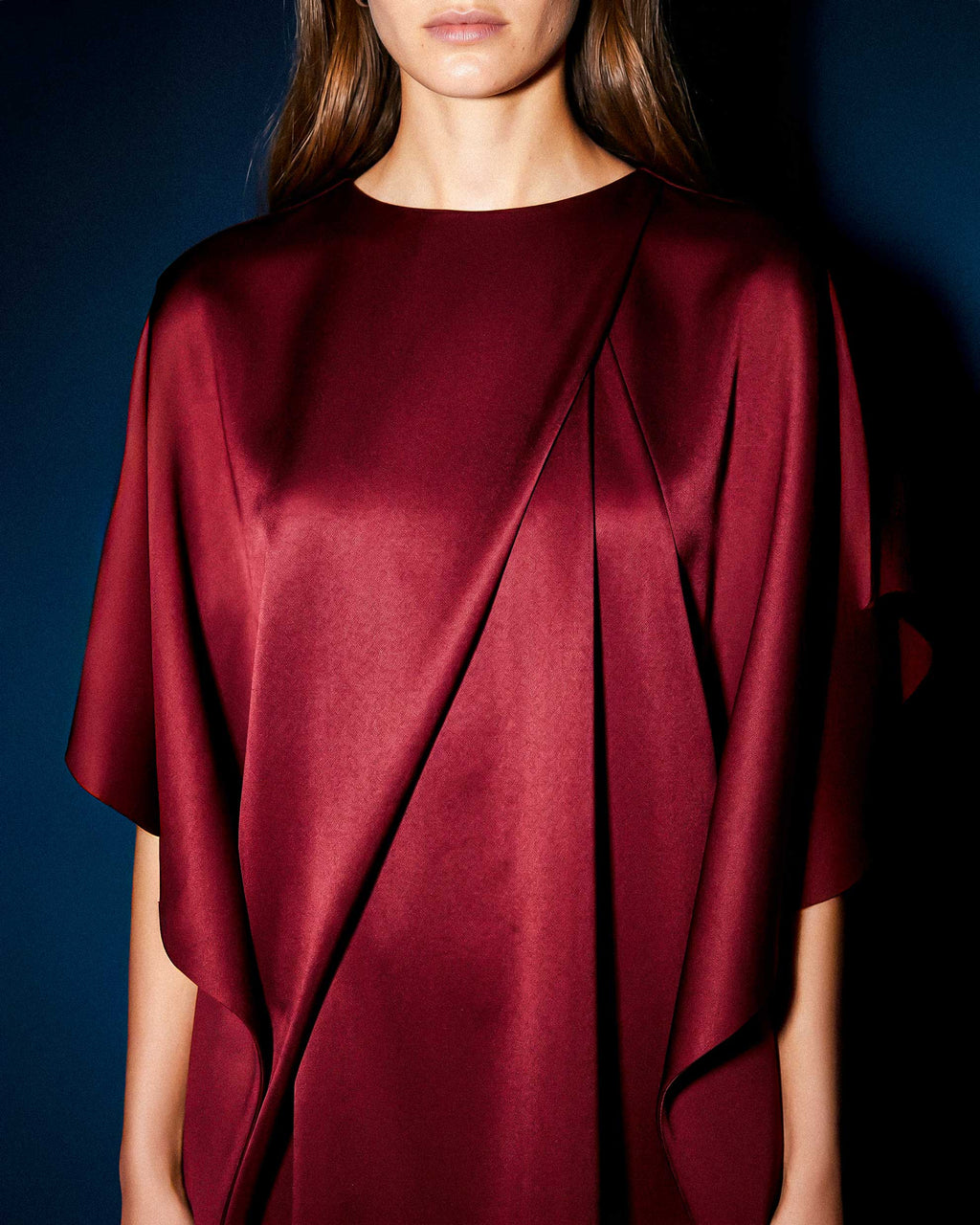 Detail of architectural pleat and crepe fabric on KADEN burgundy short dress by A|LOUD