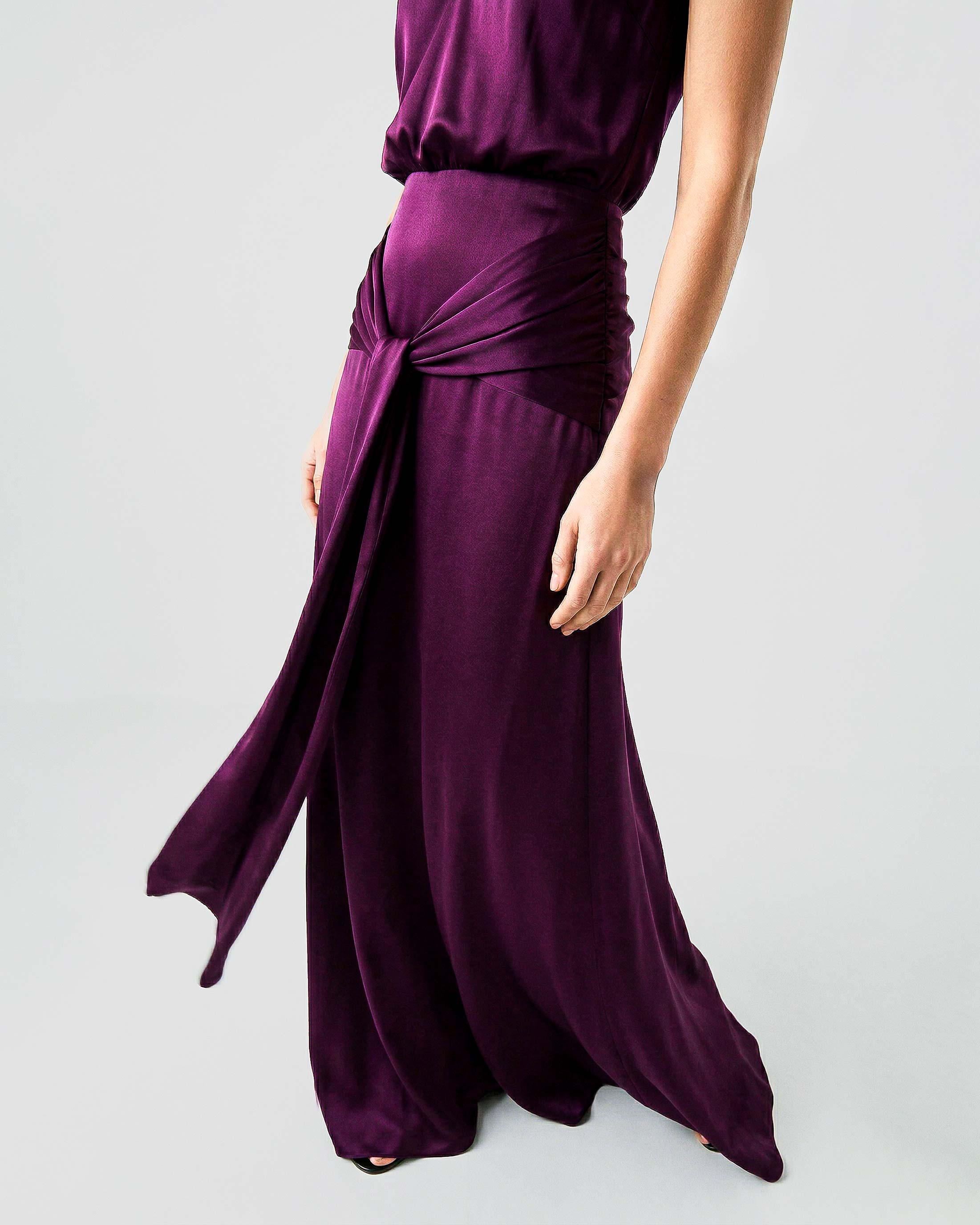Draped waist detail on burgundy satin evening gown