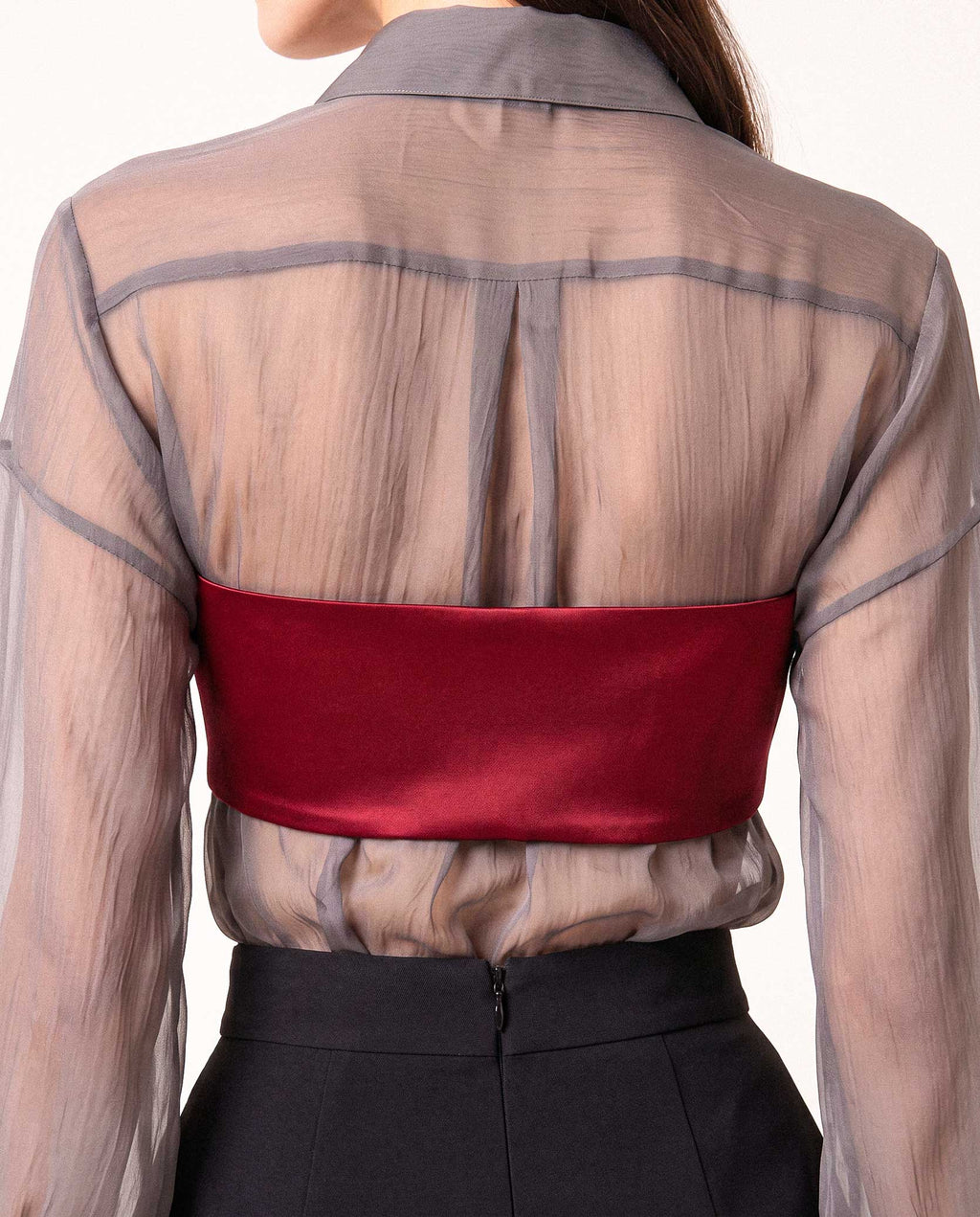 Back styling detail of the ÉLYR burgundy silk satin bandeau layered over the sheer charcoal silk chiffon shirt by A|LOUD
