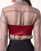 Back styling detail of the ÉLYR burgundy silk satin bandeau layered over the sheer charcoal silk chiffon shirt by A|LOUD