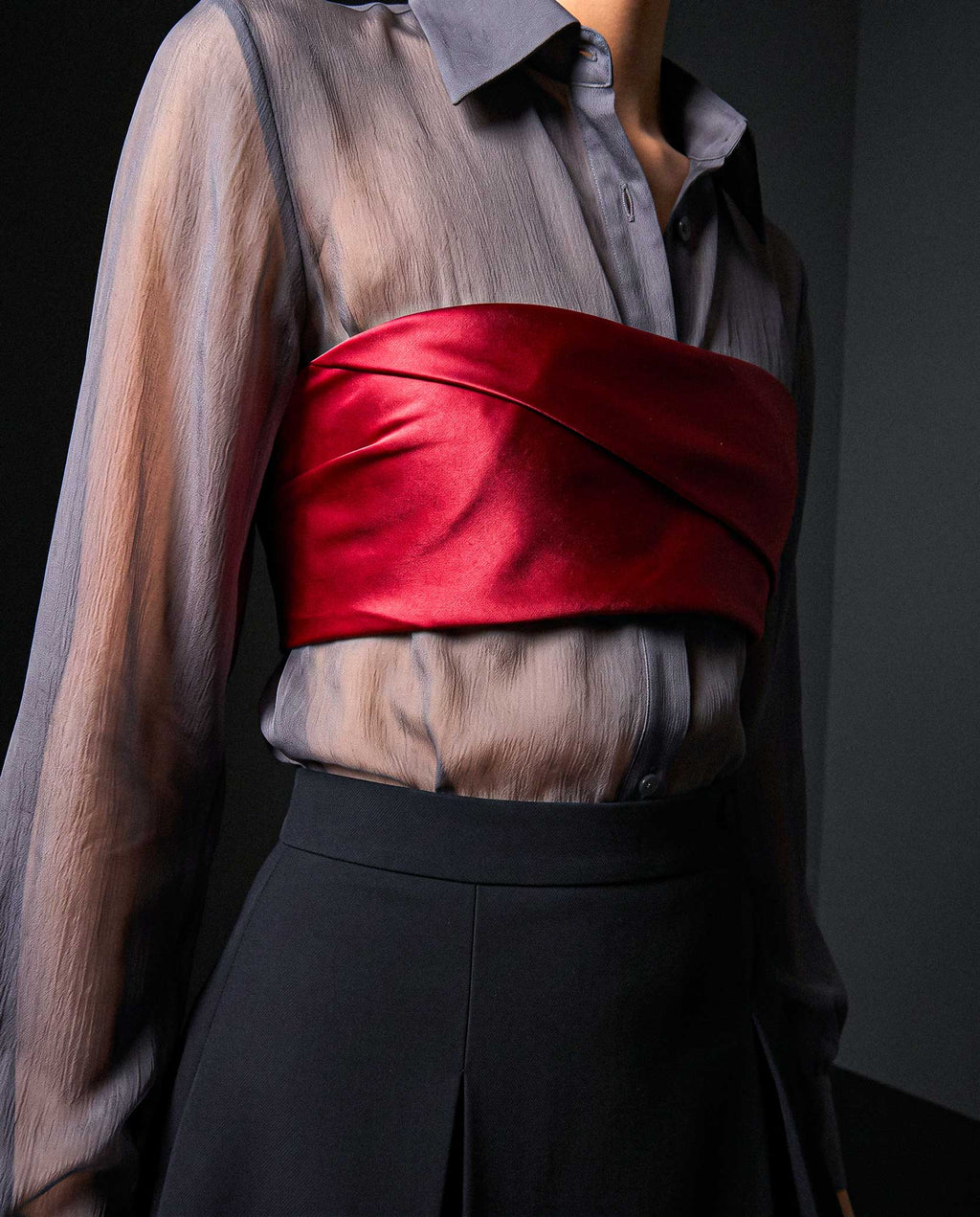 Side detail of the ÉLYR burgundy silk satin bandeau showing the sculptural satin wrap over a sheer charcoal silk chiffon shirt by A|LOUD