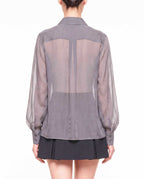 Back detail of the ÉLYR sheer charcoal silk chiffon shirt showing the transparent silk chiffon, back yoke and voluminous sleeves by A|LOUD