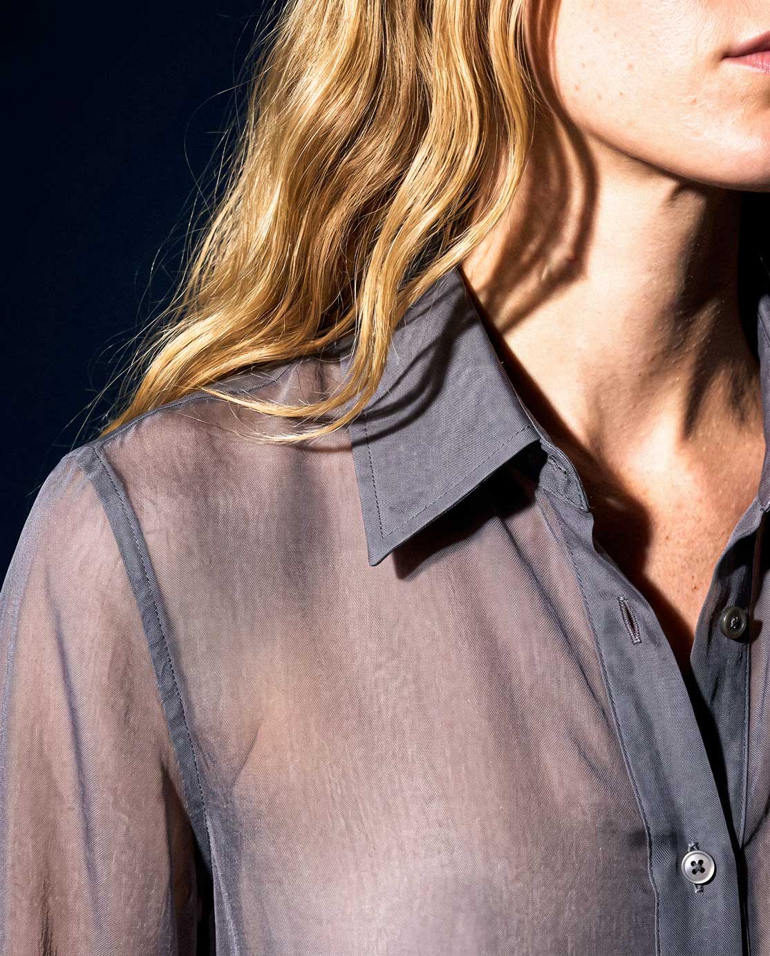 Close-up detail of the ÉLYR sheer charcoal silk chiffon shirt with pointed collar and transparent silk texture by A|LOUD