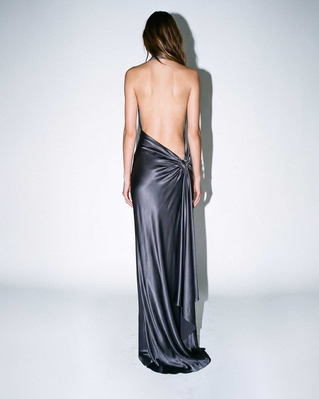 Full back view of MIREILLE silk satin evening gown with open back and draped sash detail