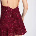 Close-up of low open back and satin piping – Lioren mini dress in red
