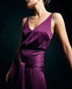 Deep V neckline detail on burgundy satin evening dress