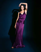 Purple satin evening dress with deep neckline and fluid full-length silhouette