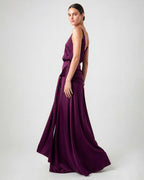 Side view of burgundy satin evening dress with fluid silhouette