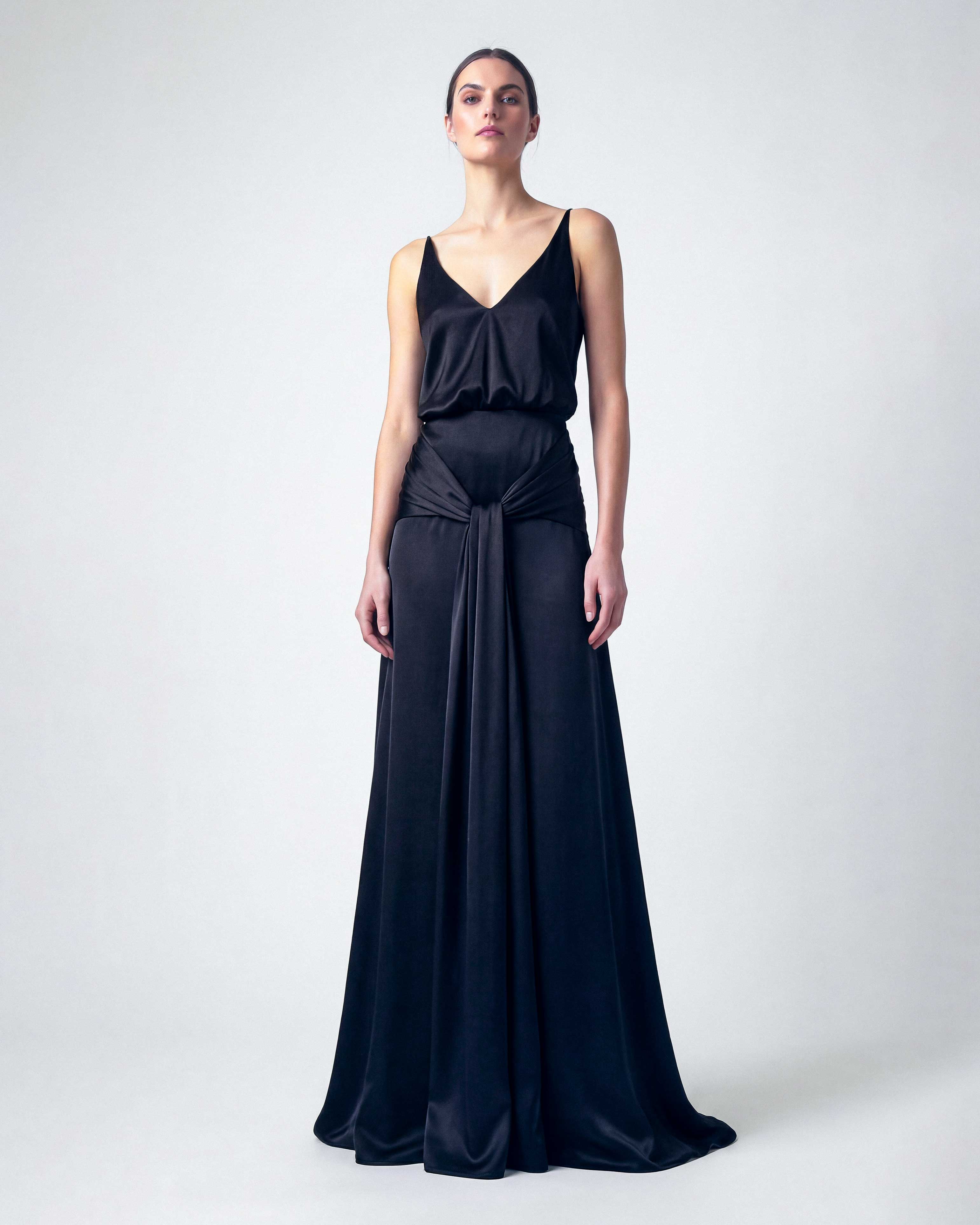 black satin evening dress with deep V neckline and draped waist
