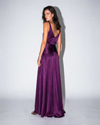 Purple satin evening gown captured in motion with fluid skirt and open back
