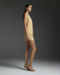 Side view of butter yellow satin halter top