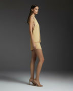 Side view of butter yellow satin halter top