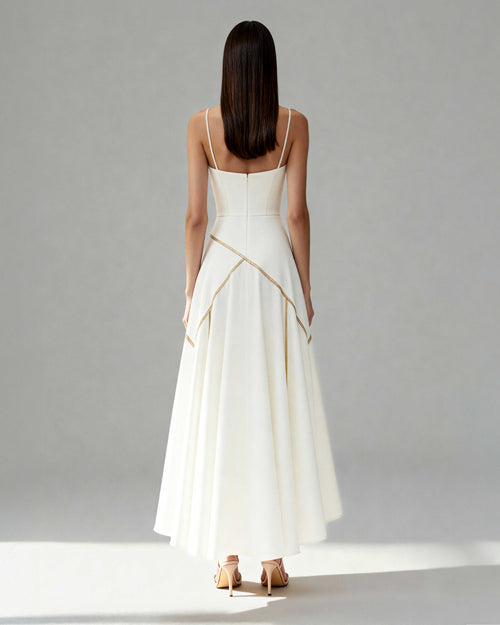 Back view of Nayla midi dress showing spaghetti straps, invisible zip and curved piping detail