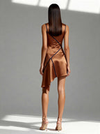 Model wearing copper satin mini dress with navy piping and draped back – back view