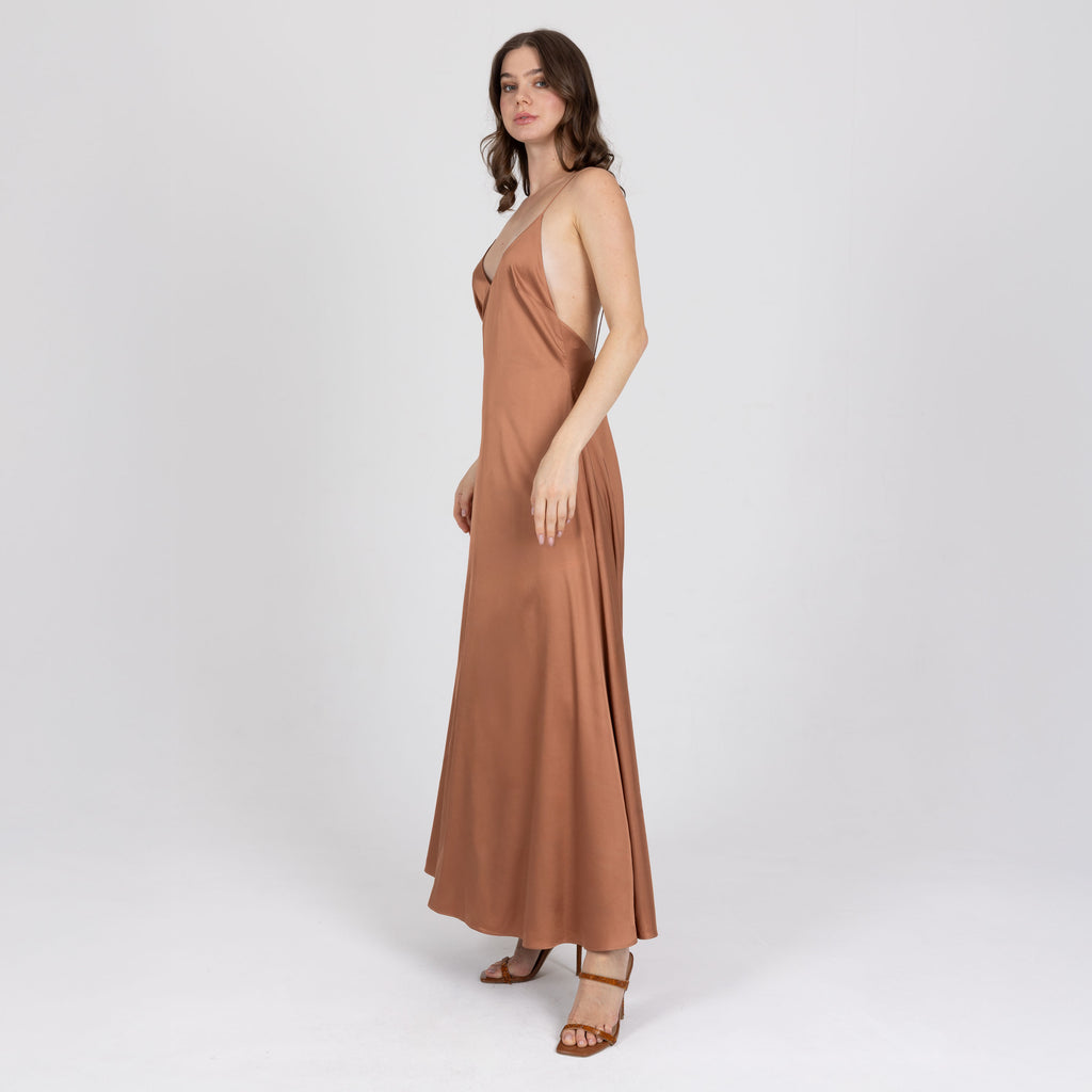 Side view of long satin slip dress in copper with liquid drape – handmade in Dubai