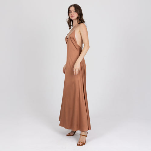 Side view of long satin slip dress in copper with liquid drape – handmade in Dubai