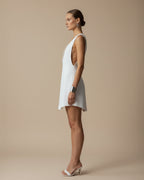 Side view of VERA white linen mini dress with clean architectural line