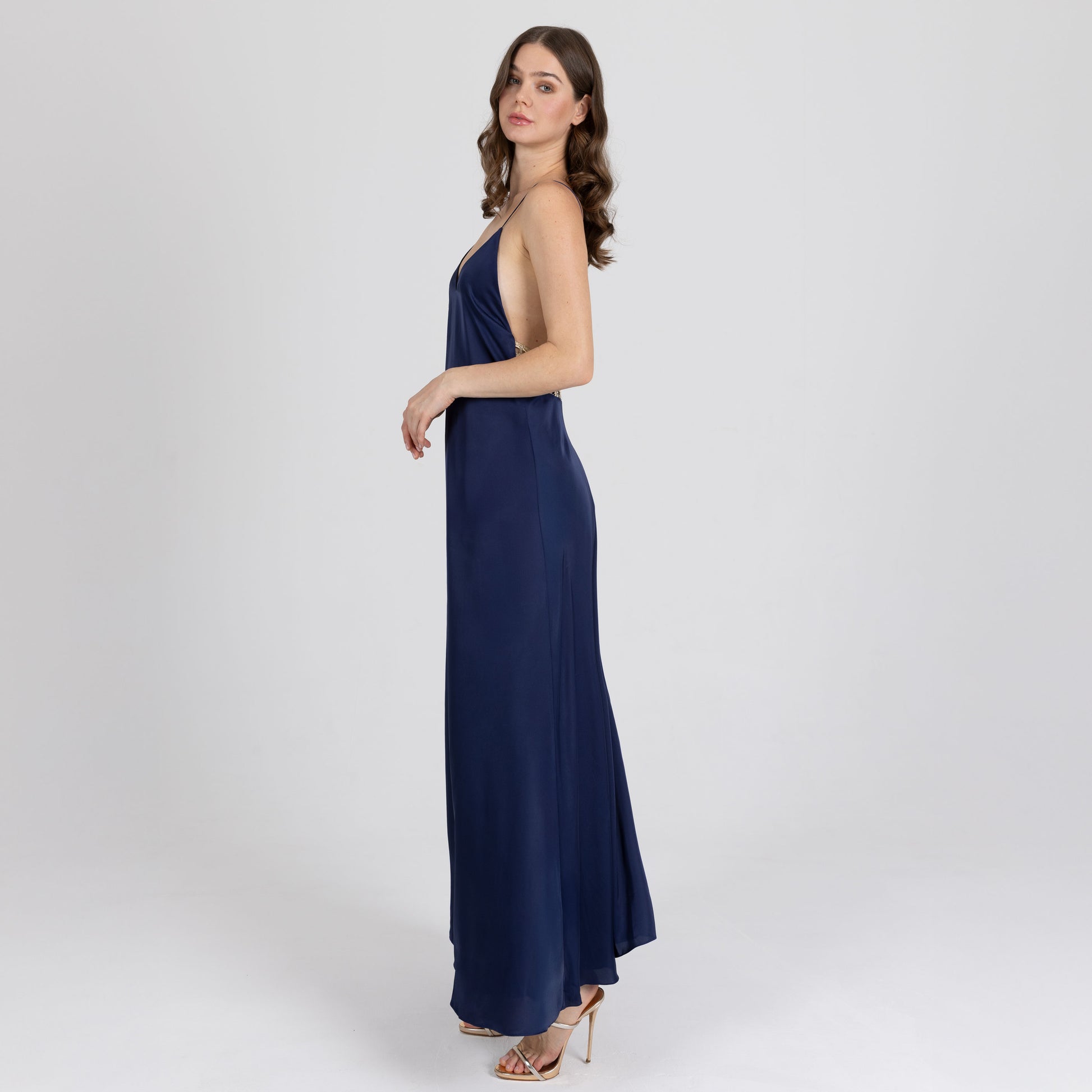 Side profile of long satin dress with soft flare and low open back – Sireya dress handmade in Dubai