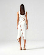 Back view of white midi dress with diagonal satin piping and asymmetric hem, highlighting the tailored back.