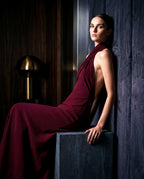 VIRENNE burgundy halter column gown by A|LOUD in luxury interior editorial setting