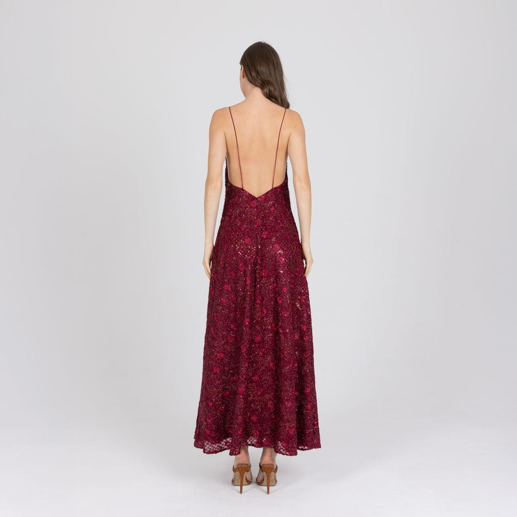 Back view of red floor-length gown with tonal embroidery and light shaping – handmade
