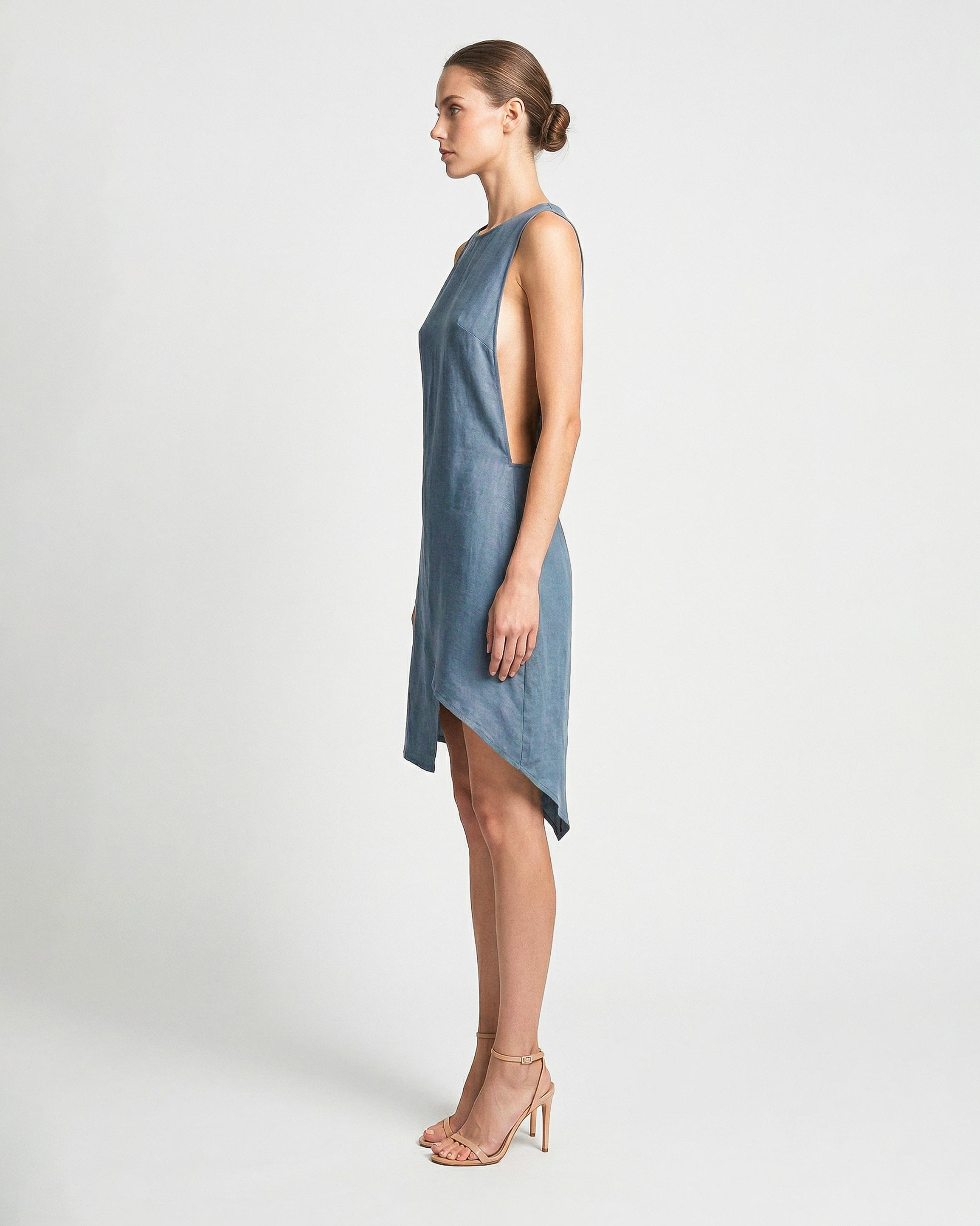 Side view of blue linen mini dress with asymmetrical hemline