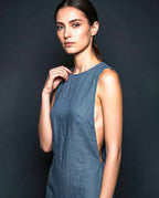 Sleeveless blue linen mini dress with clean neckline and asymmetrical construction