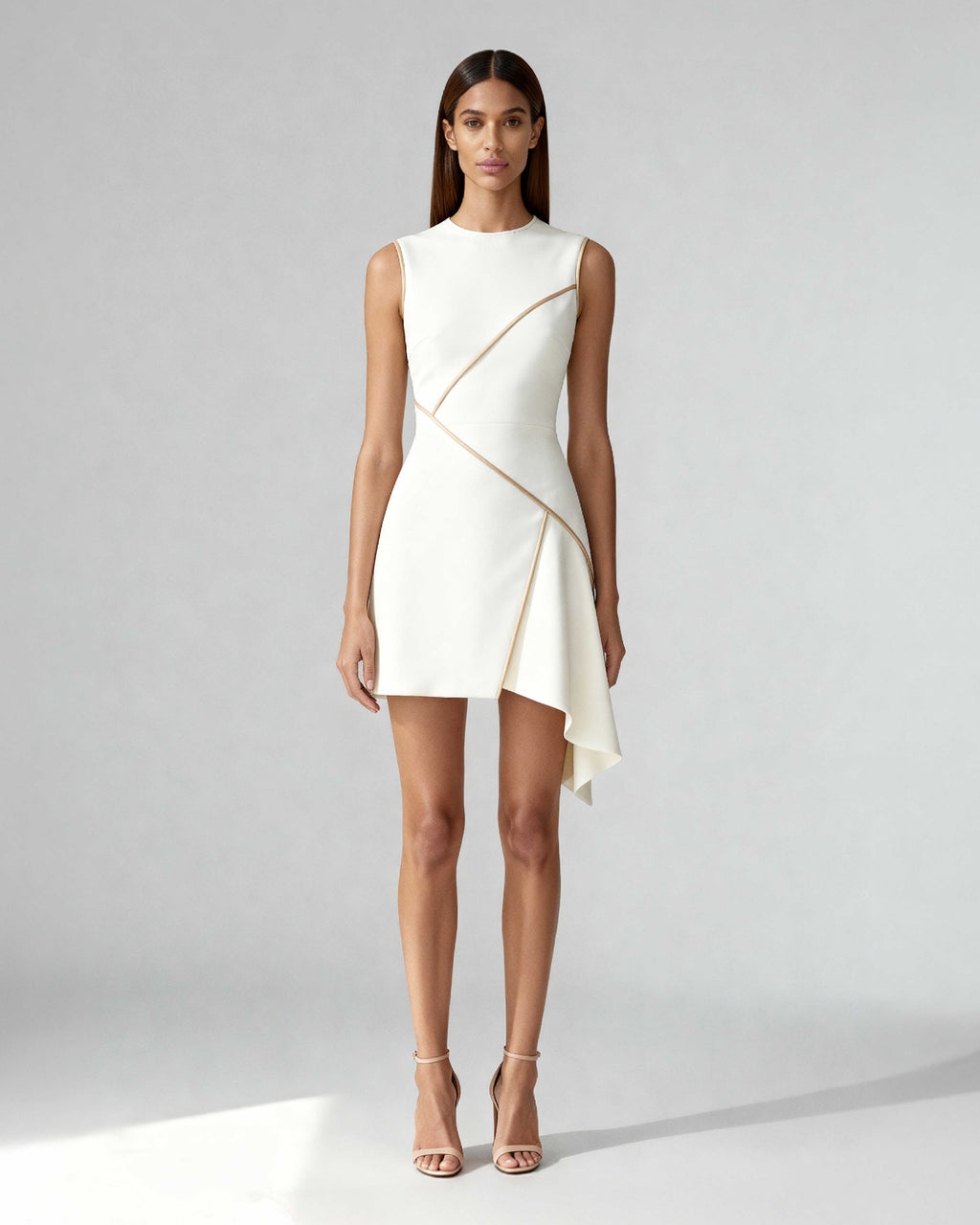 sculpted mini dress in crepe with satin piping and asymmetric lines. Made-to-order and fully lined in silk. Architectural, feminine, and timeless.