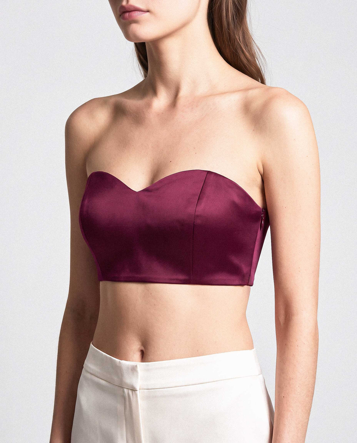 Front fit of the burgundy silk satin bandeau top featuring a sculpted sweetheart neckline