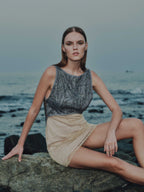 Seated model in Eline Mini Dress – cocktail look with modern elegance
