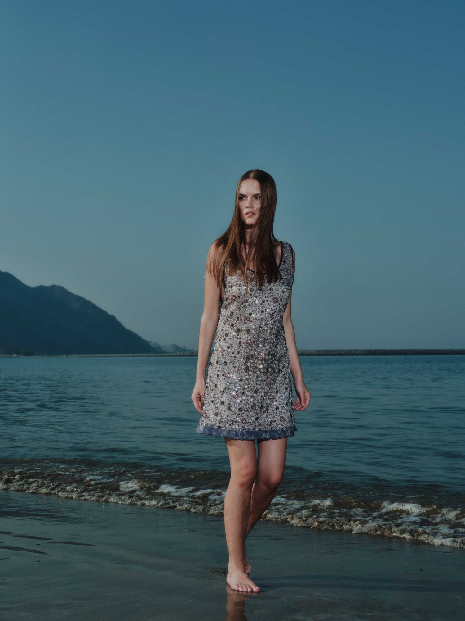 Back view of Ayla Mini Dress – sleeveless mini with light embroidery and soft volume