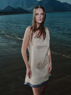 Model wearing Aurea mini dress on the beach at sunset