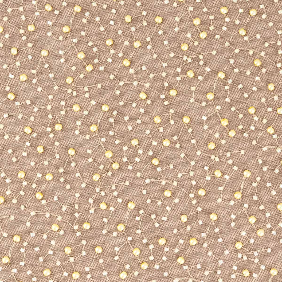Close-up of golden embroidery on Aurea tulle fabric