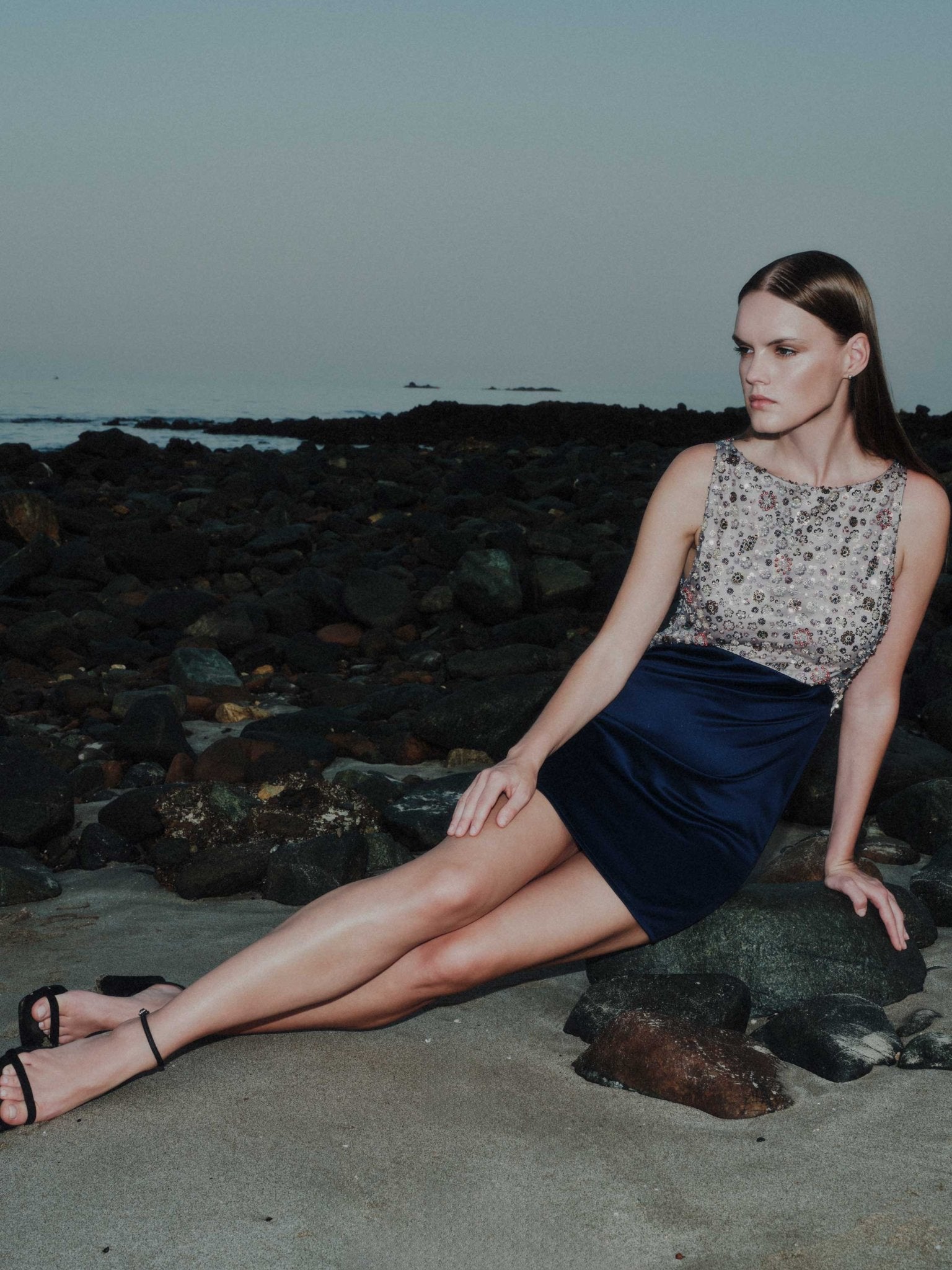 Woman wearing Maia cocktail mini dress with embroidered tulle bodice and navy silk satin skirt – front view