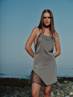 Model wearing Thalia Mini Dress on the beach – silk cocktail dress with embroidered tulle insert